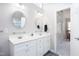 Clean bathroom featuring double sinks, white cabinets, modern fixtures, and coordinated decor at 1113 Pilton Pl, Raleigh, NC 27604