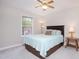Cozy bedroom with ceiling fan, natural light, and coordinated furniture at 1113 Pilton Pl, Raleigh, NC 27604
