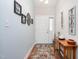 Welcoming foyer with wood flooring, a console table, and decorative wall art at 1113 Pilton Pl, Raleigh, NC 27604