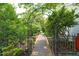 Charming garden path, framed by lush greenery and an archway, adding natural beauty to the property at 1113 Pilton Pl, Raleigh, NC 27604