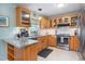 Well-lit kitchen with granite counters, stainless steel appliances, and warm wood cabinetry at 1113 Pilton Pl, Raleigh, NC 27604