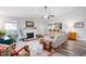 Bright living room with a cozy fireplace, vaulted ceilings, ceiling fan and stylish decor at 1113 Pilton Pl, Raleigh, NC 27604