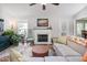 Comfortable living room featuring a fireplace, neutral walls, and view to the dining area at 1113 Pilton Pl, Raleigh, NC 27604