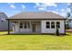 Well-maintained backyard featuring a spacious patio and lush green grass, perfect for outdoor enjoyment at 112 Cultivator Ct, Angier, NC 27501