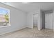 Comfortable bedroom providing access to a walk-in closet and showcasing a window with an outdoor view at 112 Cultivator Ct, Angier, NC 27501