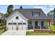 Charming home with a two-car garage, inviting front porch, and lovely blue front door at 112 Cultivator Ct, Angier, NC 27501