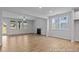 Bright open-concept living room with fireplace and multiple windows at 112 Cultivator Ct, Angier, NC 27501