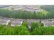 Aerial view of a community with lush trees, well-maintained landscaping, and nearby amenities at 112 River Dell Townes Ave, Clayton, NC 27527