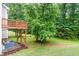 Expansive backyard featuring a wooden deck and mature trees, offering a serene outdoor space at 112 River Dell Townes Ave, Clayton, NC 27527