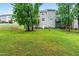 Expansive backyard with mature trees and a gentle slope, perfect for outdoor activities at 112 River Dell Townes Ave, Clayton, NC 27527