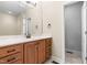 Bathroom featuring a vanity with drawers, a mirror, and access to the shower and walk in closet at 112 River Dell Townes Ave, Clayton, NC 27527