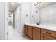 Bathroom with tile floors, wood vanity, white countertop, large mirror, and modern fixtures at 112 River Dell Townes Ave, Clayton, NC 27527