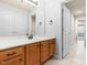 Bathroom with tile floors, wood vanity, white countertop, and modern fixtures at 112 River Dell Townes Ave, Clayton, NC 27527