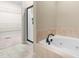 Bathroom showcasing a soaking tub and shower adjacent to the walk-in closet at 112 River Dell Townes Ave, Clayton, NC 27527