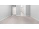 Bright bedroom with neutral carpet, showing a view of the hall and staircase at 112 River Dell Townes Ave, Clayton, NC 27527