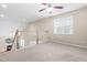 Loft-style bonus room with cozy carpeting, white railings, and a window with natural light at 112 River Dell Townes Ave, Clayton, NC 27527