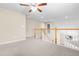 Upstairs bonus room offers neutral walls, carpeting, and a ceiling fan for added comfort at 112 River Dell Townes Ave, Clayton, NC 27527