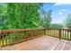 Relax on this wooden deck, perfect for entertaining or enjoying peaceful views of the backyard at 112 River Dell Townes Ave, Clayton, NC 27527