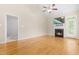 Bright living room with hardwood floors, a fireplace, and high ceilings leading to an outdoor patio at 112 River Dell Townes Ave, Clayton, NC 27527