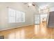 Spacious living room boasts hardwood floors, large windows, and an open layout with stair access at 112 River Dell Townes Ave, Clayton, NC 27527