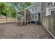 View of the backyard featuring a covered deck, lush landscaping, wooden fence and a multi-level design at 1200 Collington Dr, Cary, NC 27511