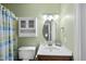 Cozy bathroom with cabinet storage, decorative oval mirror, light fixture and light green painted walls at 1200 Collington Dr, Cary, NC 27511
