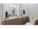 Well-maintained powder room featuring a round mirror and decorative towels adjacent to a toilet at 1200 Collington Dr, Cary, NC 27511