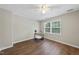 Sunlit bedroom with wood floors, a desk with decor, and a ceiling fan, offering a peaceful atmosphere at 1200 Collington Dr, Cary, NC 27511