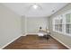 Bright bedroom with wood flooring, complemented by a small desk setup and a ceiling fan for comfort at 1200 Collington Dr, Cary, NC 27511