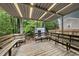 Spacious covered wooden deck, with built in seating, providing a private outdoor entertaining area at 1200 Collington Dr, Cary, NC 27511