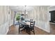 Bright dining room with modern chandelier and sliding glass doors to outdoor space at 1200 Collington Dr, Cary, NC 27511