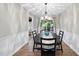 Elegant dining room with a black table, chandelier, and access to an outdoor space at 1200 Collington Dr, Cary, NC 27511