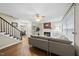 Open living room with hardwood floors, fireplace, and a view of the staircase at 1200 Collington Dr, Cary, NC 27511