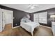 Cozy main bedroom featuring dark walls, wood floors, and a soft bed with decorative pillows at 1200 Collington Dr, Cary, NC 27511
