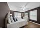Comfortable main bedroom with plush bedding, wood floors, complemented by ample natural light at 1200 Collington Dr, Cary, NC 27511