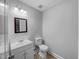 Bathroom features a white vanity with mirror and toilet at 1216 Briarwood Dr, Mebane, NC 27302