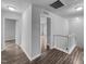 Upstairs hallway with wood-look floors connects to multiple rooms and stairs to other floors at 1216 Briarwood Dr, Mebane, NC 27302