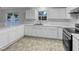 Kitchen features white cabinetry, white subway tile, and modern stainless steel appliances at 1216 Briarwood Dr, Mebane, NC 27302