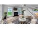 Bright living room featuring a fireplace, hardwood floors, and modern decor at 1216 Briarwood Dr, Mebane, NC 27302