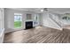 Spacious living area with large windows, hardwood floors, and a cozy fireplace at 1216 Briarwood Dr, Mebane, NC 27302