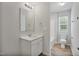 Well-lit bathroom featuring a modern vanity, a large mirror, and a combined shower and tub at 124 Teagarden Ct, Sanford, NC 27332