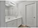 Bathroom features double sinks, framed mirrors, wood-look flooring, and white cabinets and trim at 124 Teagarden Ct, Sanford, NC 27332