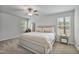 Bright bedroom featuring a ceiling fan, neutral walls, carpeted floors, and natural light from two windows at 124 Teagarden Ct, Sanford, NC 27332