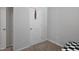 Bedroom walk-in closet with a white door, off a cozy carpeted bedroom at 124 Teagarden Ct, Sanford, NC 27332