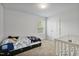 bedroom with carpet, a window, and a toddler bed next to a crib at 124 Teagarden Ct, Sanford, NC 27332