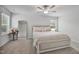 Bright bedroom featuring a ceiling fan, neutral walls, carpeted floors, a gold mirror and natural light from two windows at 124 Teagarden Ct, Sanford, NC 27332