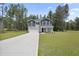 Two-story home with blue shutters, light gray siding, a front porch and a paved driveway at 124 Teagarden Ct, Sanford, NC 27332