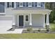 Inviting front porch with decorative pillars, stone accents, and a welcoming entrance at 124 Teagarden Ct, Sanford, NC 27332