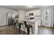 Stylish kitchen featuring a large island with granite countertops and stainless steel appliances at 124 Teagarden Ct, Sanford, NC 27332
