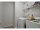 Laundry room featuring a white washer and dryer and wire shelving above at 124 Teagarden Ct, Sanford, NC 27332